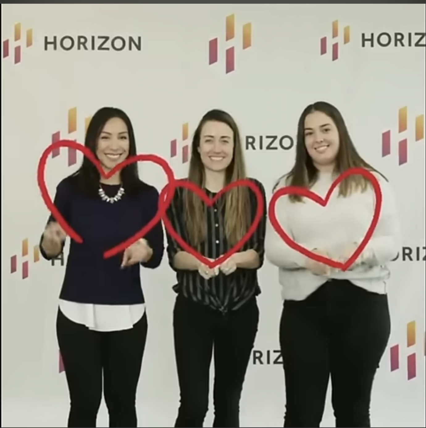Horizon team members holding hearts after Most Loved Workplace recognition