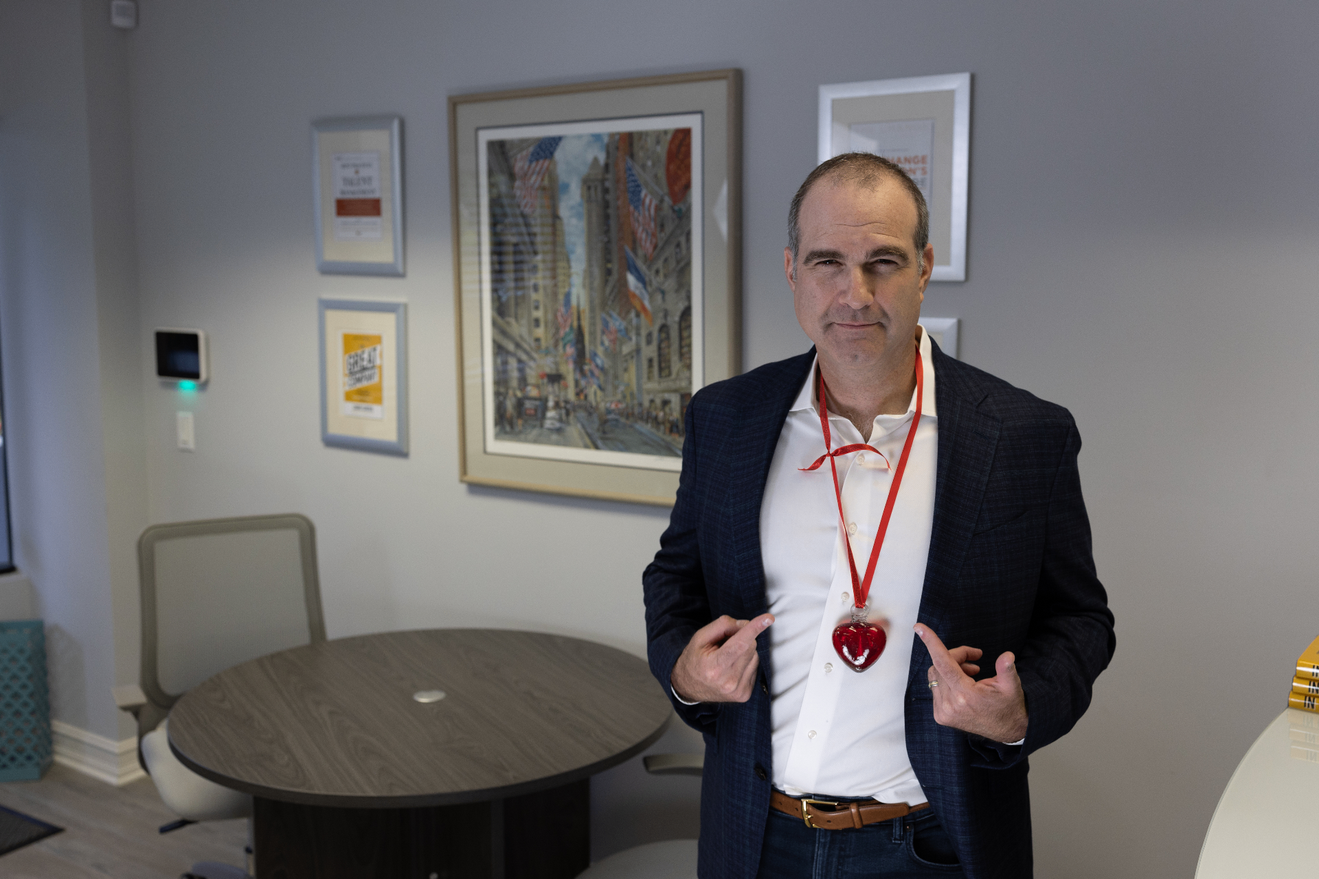 Louis Carter, Founder and CEO of Best Practice Institute, inside the BPI Palm Beach Gardens office holding the Most Loved Workplace® heart